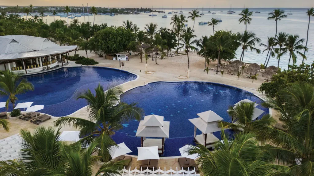 Aerial view of the infinity pool and beachfront at Secrets La Romana Resort & Spa in the Dominican Republic