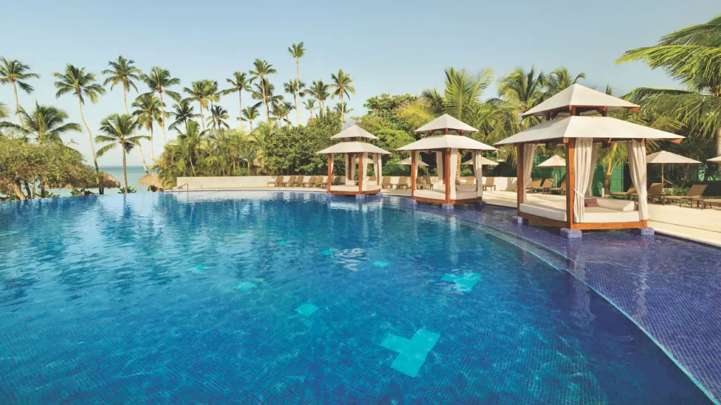 Luxury cabanas beside the infinity pool overlooking the Caribbean Sea at Secrets La Romana Resort & Spa.