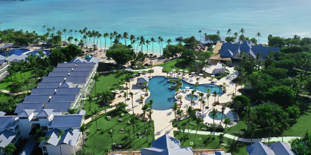 Aerial view of the main resort pool and beachfront at Secrets La Romana Resort & Spa.