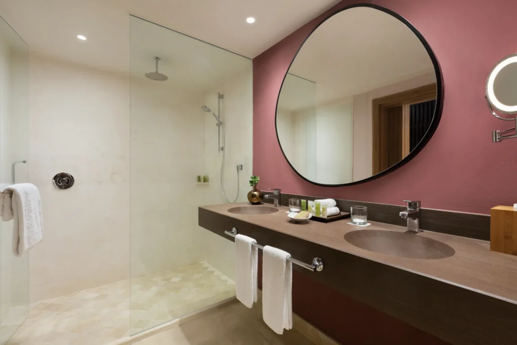 Preferred Club Pool View bathroom with rain shower and double vanity at Secrets La Romana Resort & Spa.