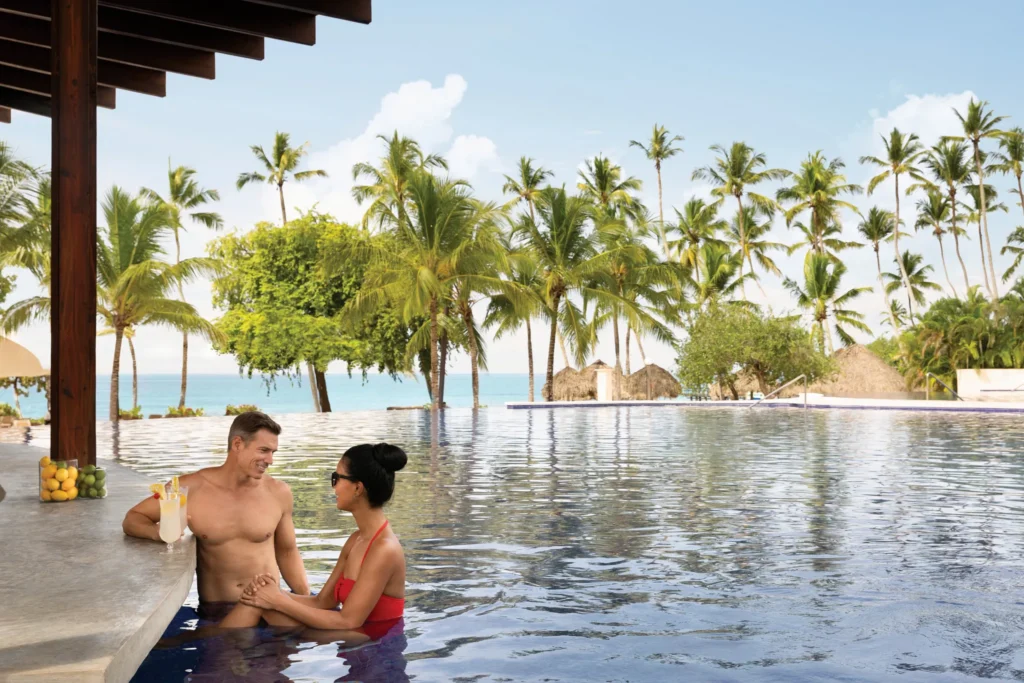 Soleil Swim-Up Bar at Secrets La Romana Resort & Spa featuring refreshing cocktails, poolside seating, and tropical resort views.