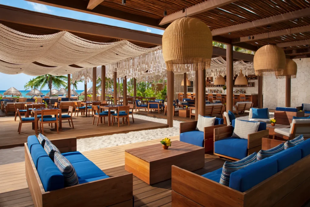 Beachfront restaurant and lounge seating with ocean views at Secrets Maroma Beach Riviera Cancun.