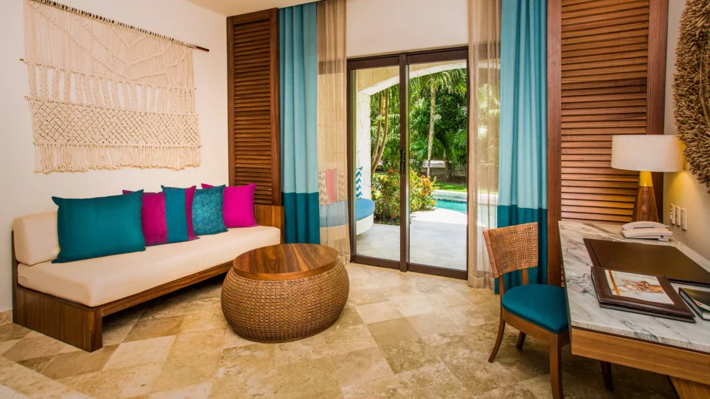 Junior Suite Swim Out sitting area with sofa and terrace access at Secrets Maroma Beach Riviera Cancun.