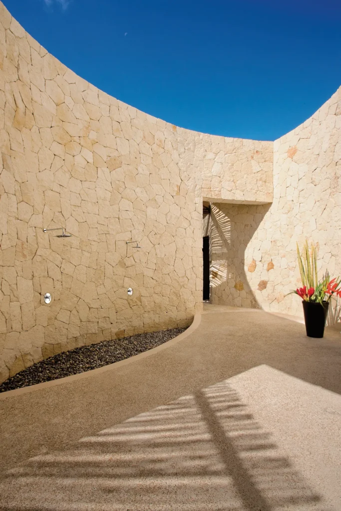 Open-air stone shower area at Secrets Maroma Beach Riviera Cancun spa.