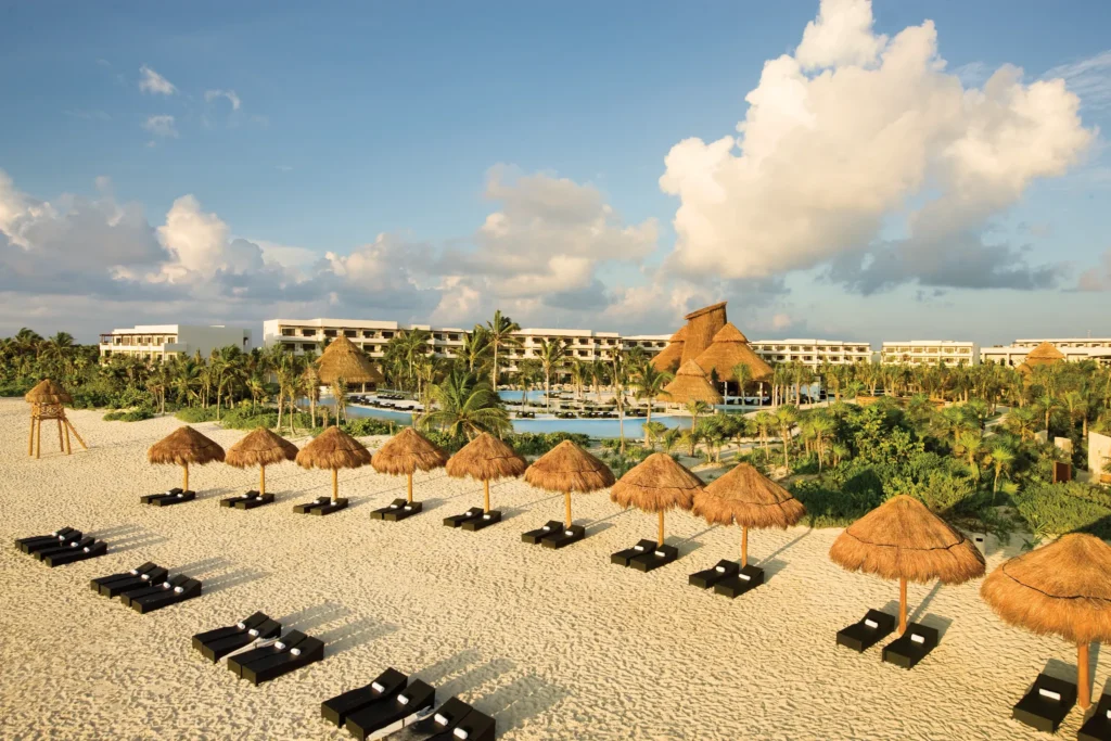Aerial view of Secrets Maroma Beach Riviera Cancun overlooking white-sand beach and infinity pools.