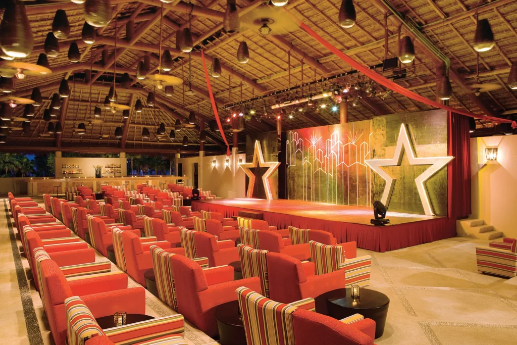 Showtime Theater Bar stage and seating area at Secrets Maroma Beach Riviera Cancun with nightly entertainment.