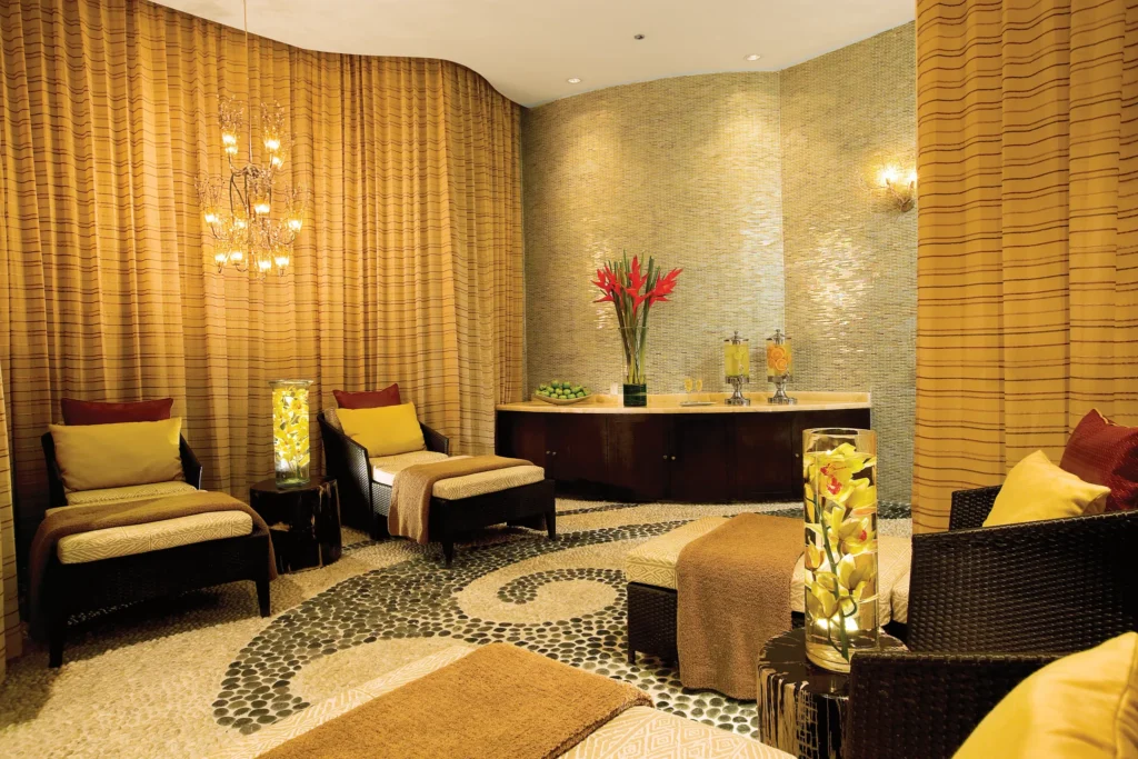 Elegant spa relaxation room with lounge chairs and soft lighting at Secrets Maroma Beach Riviera Cancun.