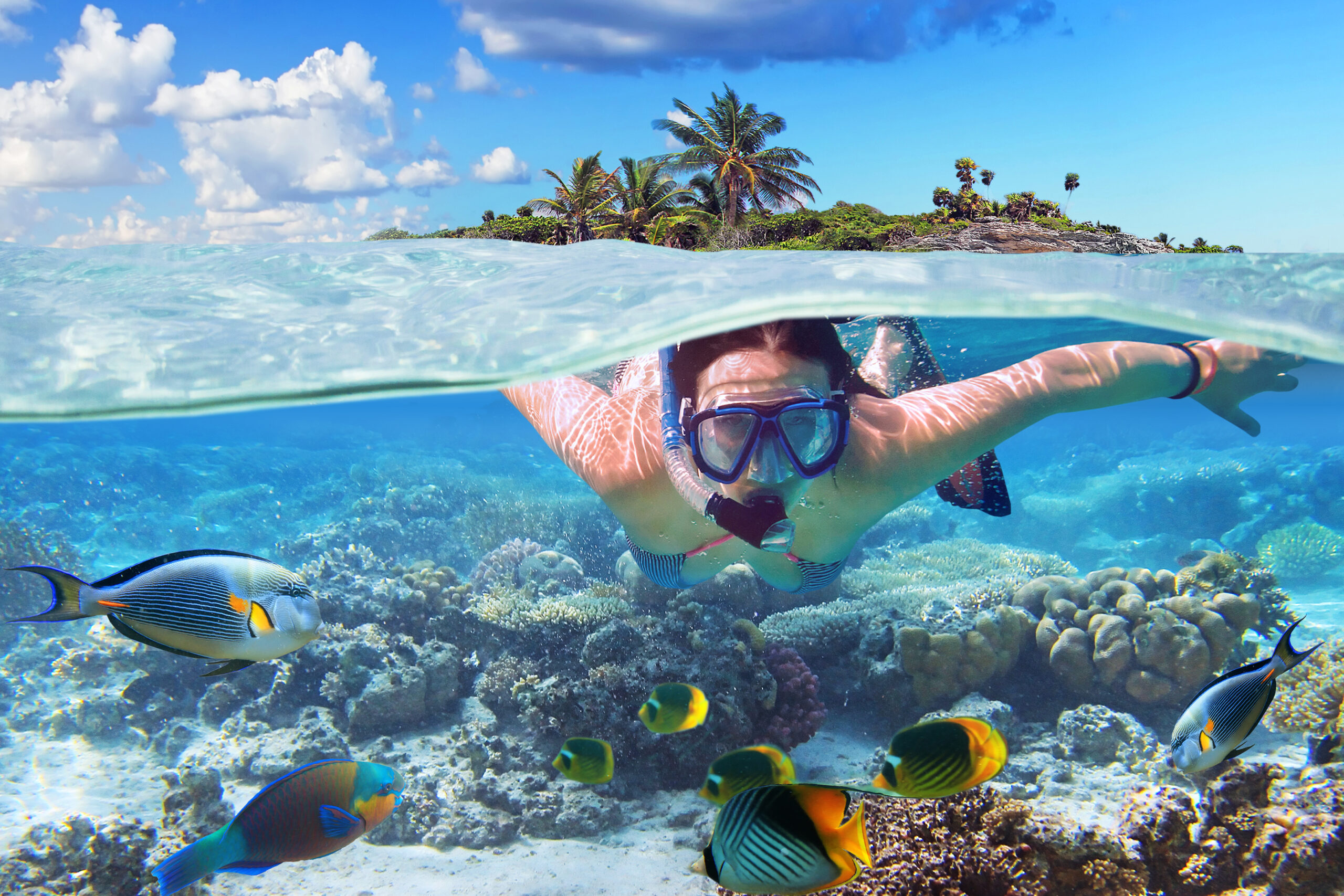 Young woman at snorkeling in the tropical water