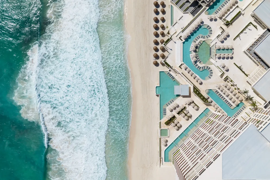 Aerial view of pools and beachfront at Secrets Mirabel Cancun Resort & Spa in Cancun’s Hotel Zone.