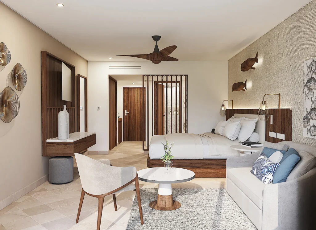 Deluxe Lagoon View Balcony suite with king bed, sofa seating area, and furnished balcony at Secrets Mirabel Cancun Resort & Spa.