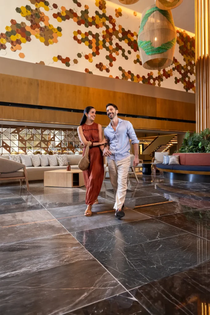 Couple walking through the luxurious lobby at Secrets Mirabel Cancun Resort & Spa in Cancun.
