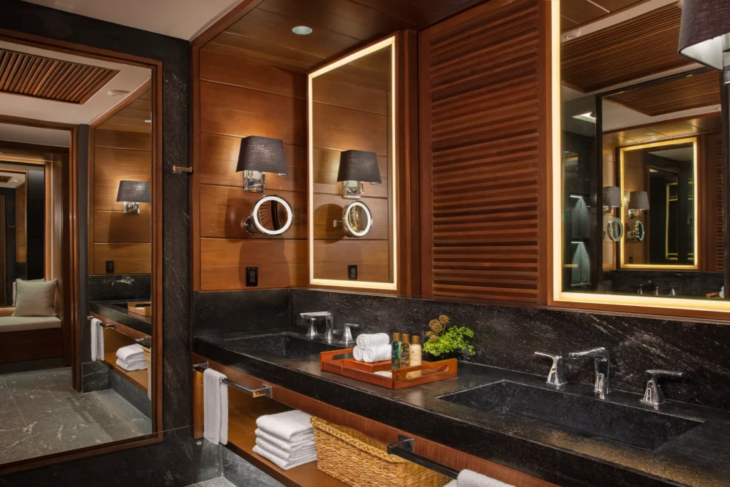 Junior Suite Tropical View bathroom with double sinks and illuminated mirrors at Secrets Moxché Playa del Carmen.