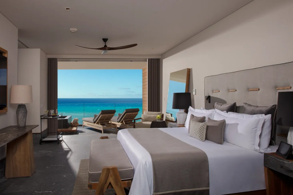 Preferred Club Master Suite Oceanfront bedroom with king bed and terrace overlooking the Caribbean at Secrets Moxché Playa del Carmen.