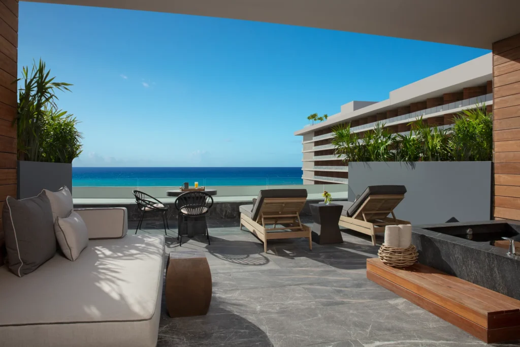 Preferred Club Superior Junior Suite Ocean View terrace with lounge chairs and soaking tub at Secrets Moxché Playa del Carmen.