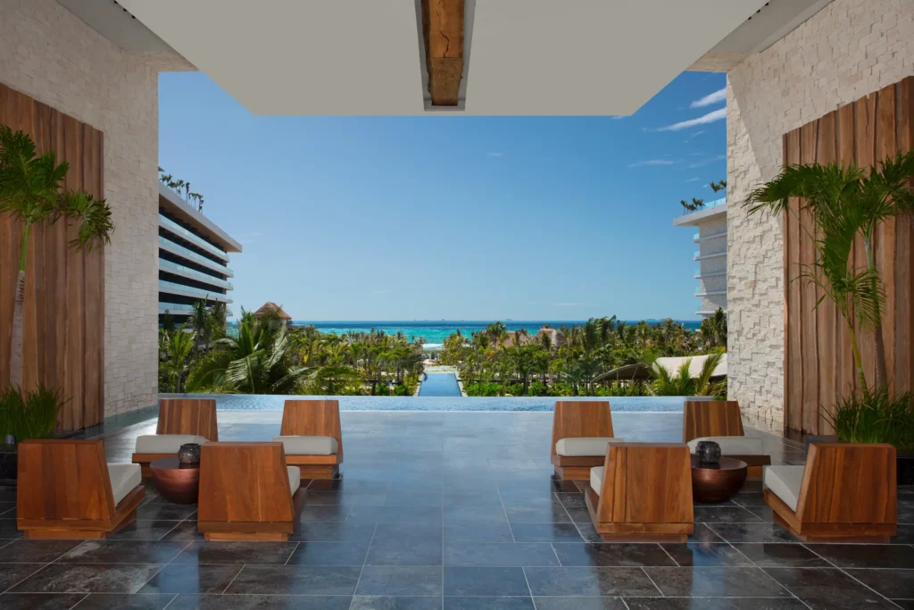 Grand open-air arrival lobby with ocean views at Secrets Moxché Playa Del Carmen adults-only luxury resort.