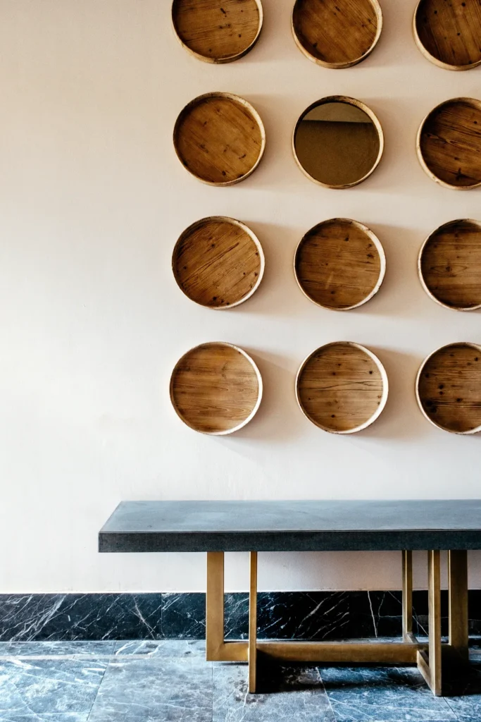 Decorative wall with circular wooden art installation in the modern interior design at Secrets Moxché Playa Del Carmen.