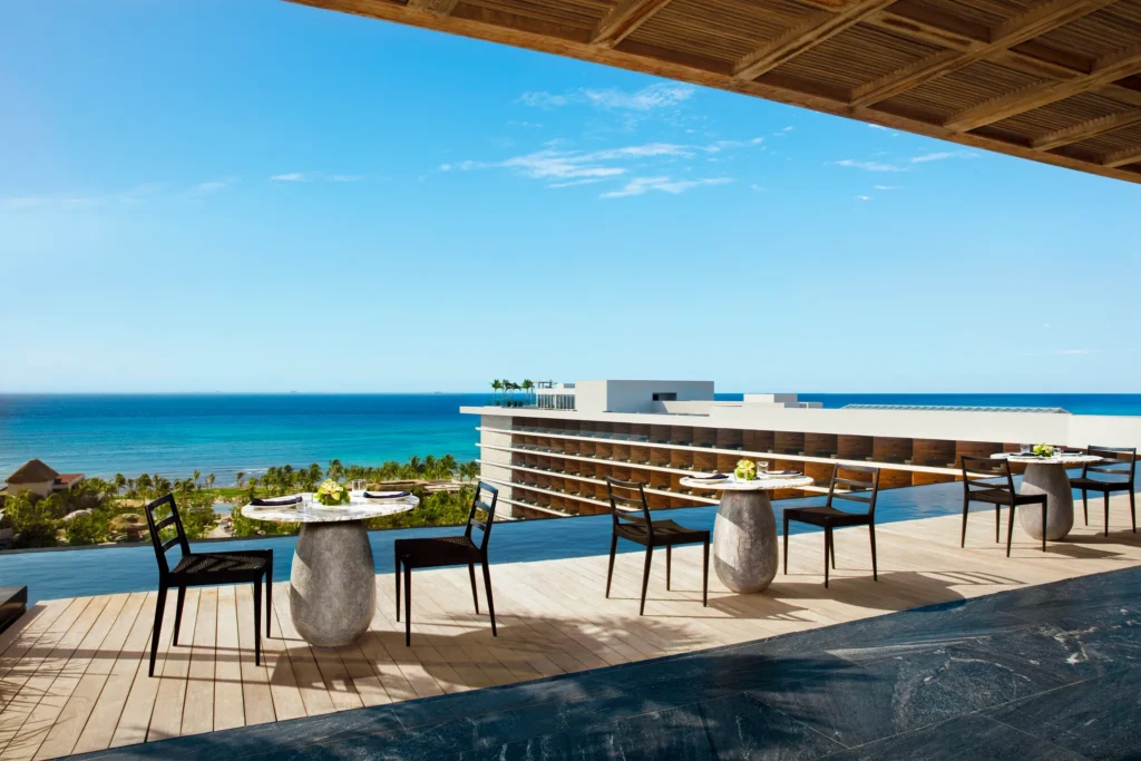 Rooftop dining terrace overlooking the Caribbean Sea at Secrets Moxché Playa Del Carmen luxury resort.