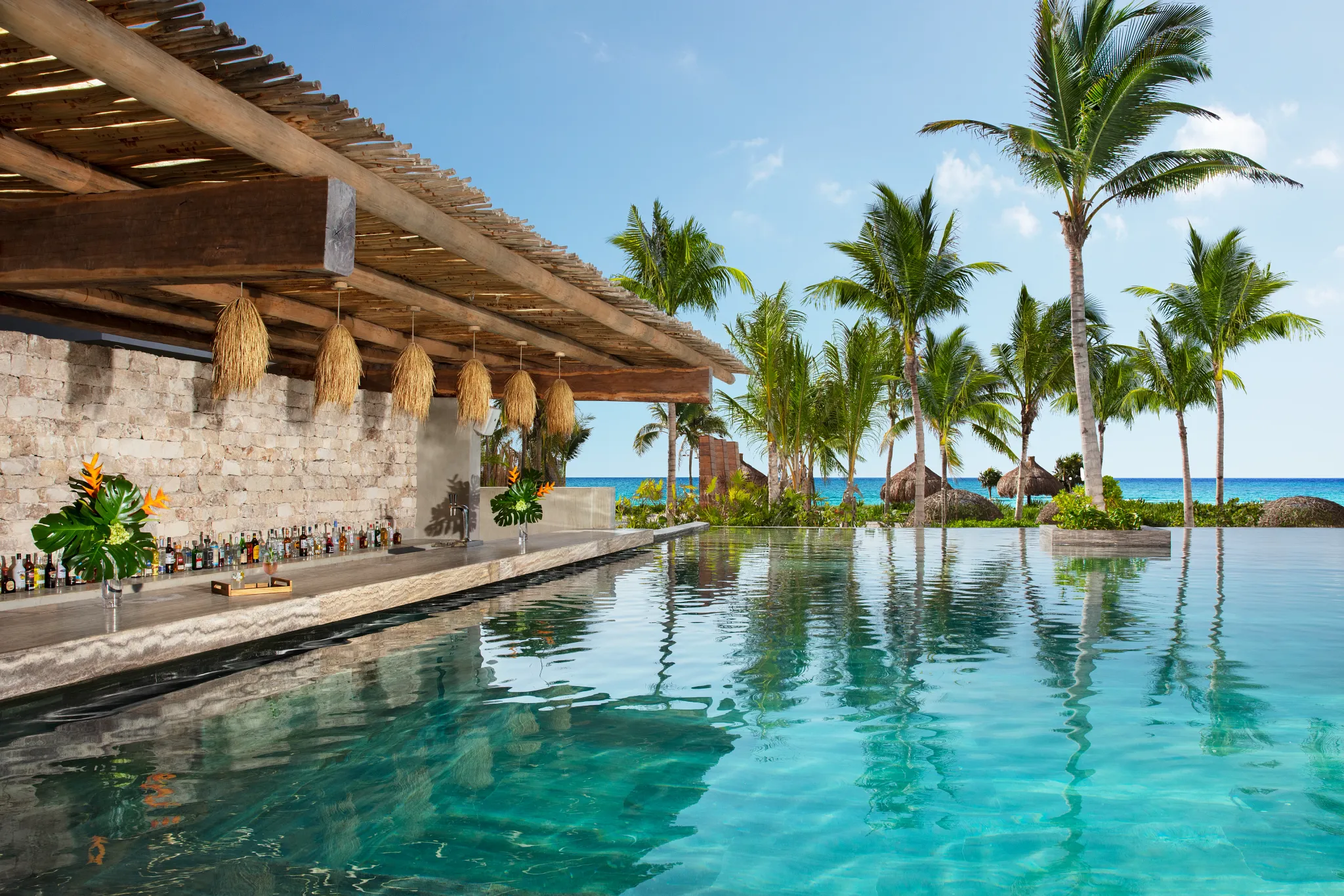 Swim-up bar at the infinity pool with ocean views at Secrets Moxché Playa Del Carmen Riviera Maya.