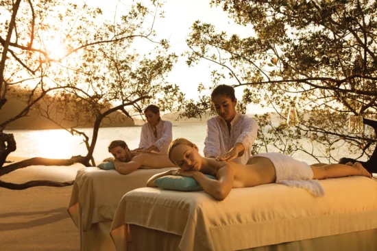 Woman enjoying a relaxing outdoor massage with ocean views at Secrets Papagayo Costa Rica.