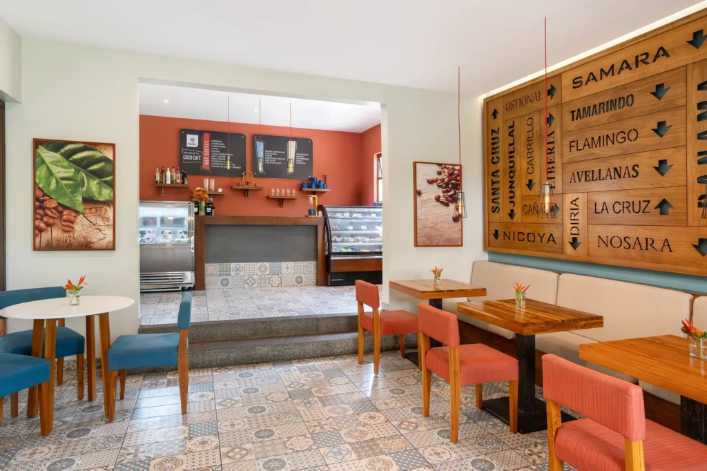 Coco Café at Secrets Papagayo Costa Rica featuring a modern coffee bar with cozy seating, tiled floors, and a welcoming café atmosphere.