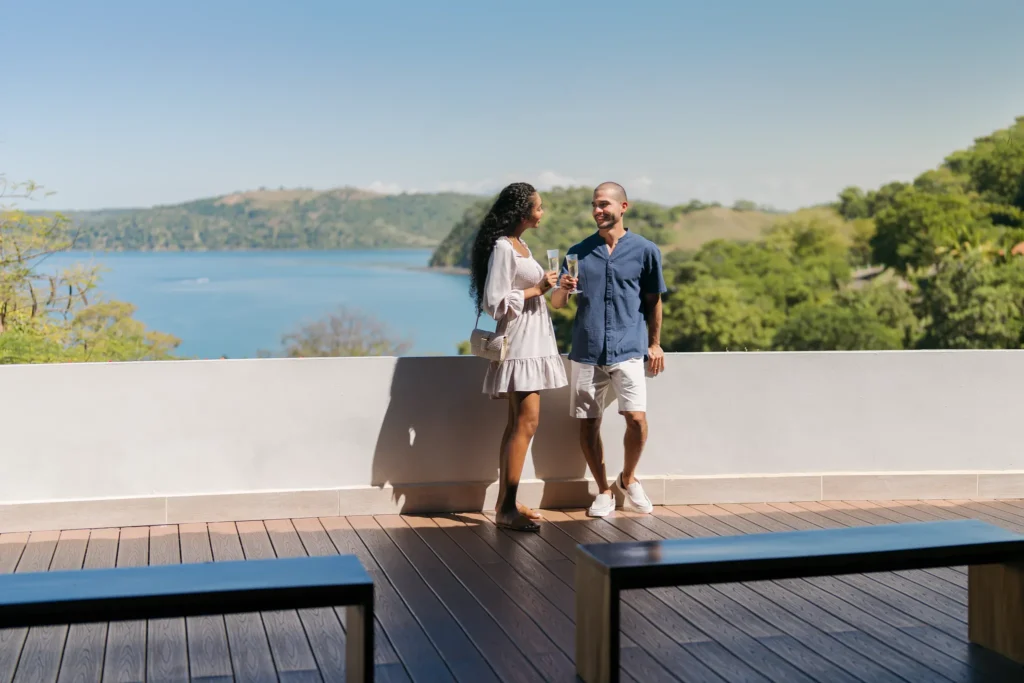 Couple enjoying panoramic bay views from the open-air lobby at Secrets Papagayo Costa Rica.