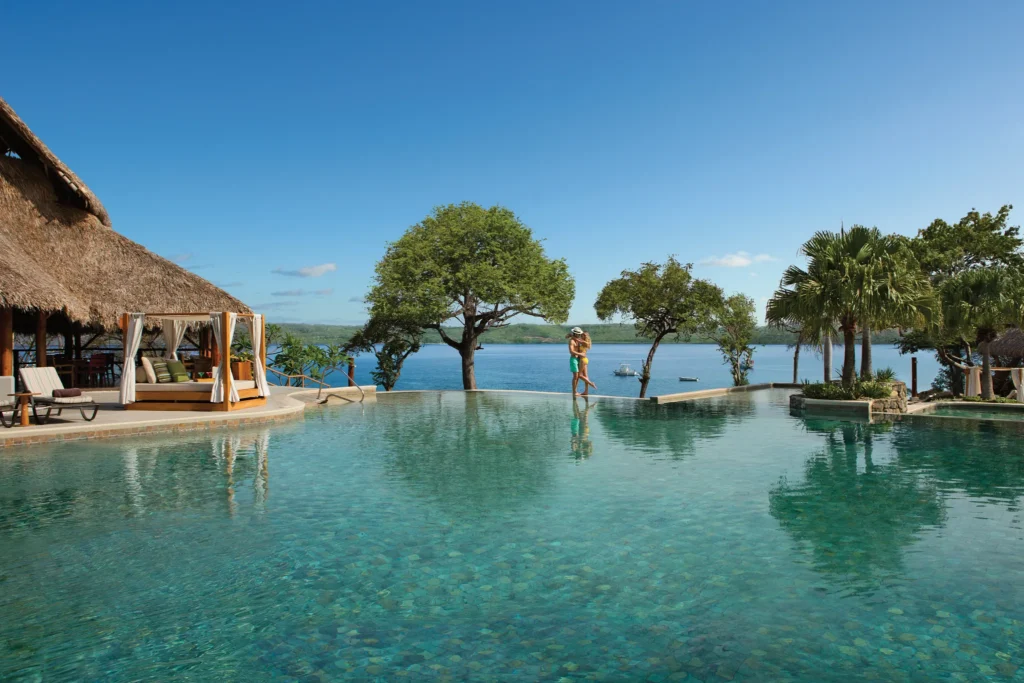 Infinity-style pool overlooking the ocean at Secrets Papagayo Costa Rica with tropical surroundings.