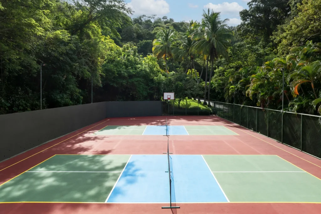 Outdoor pickleball court surrounded by tropical greenery at Secrets Papagayo Costa Rica.