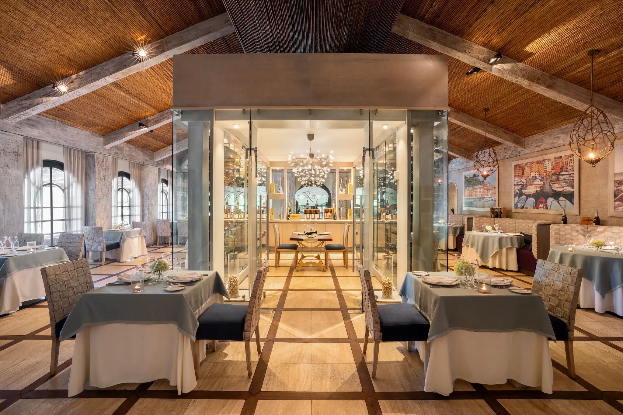 Portofino Italian Restaurant at Secrets Papagayo Costa Rica featuring an elegant dining room with refined table settings, glass wine displays, and warm Mediterranean-inspired décor.