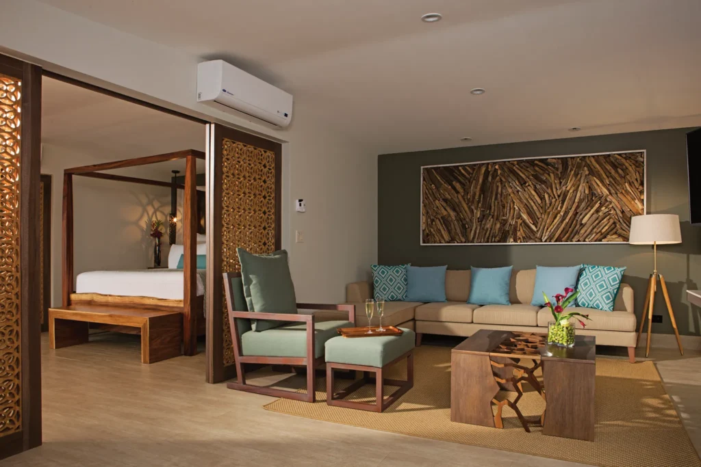 Preferred Club Honeymoon Suite living area with sofa and wood accents at Secrets Papagayo Costa Rica.