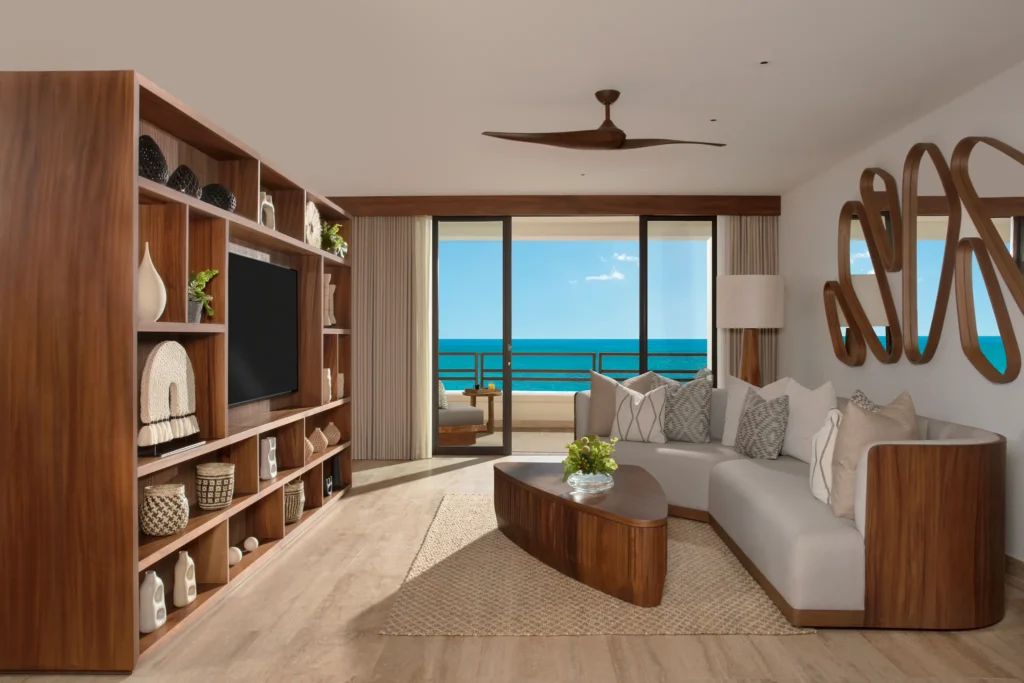 Spacious living room with sofa and ocean view balcony in Preferred Club Master Suite at Secrets Playa Blanca Costa Mujeres.