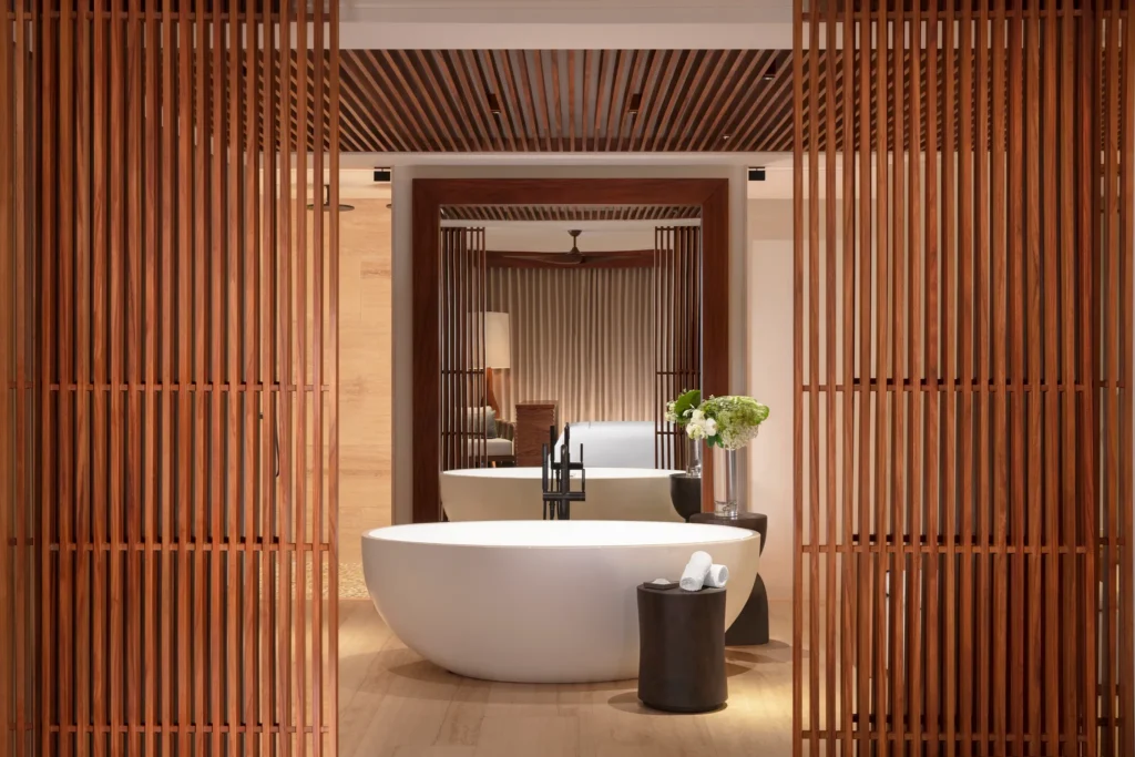 Luxury freestanding bathtub in a spacious suite bathroom at Secrets Playa Blanca Costa Mujeres with modern wood accents.