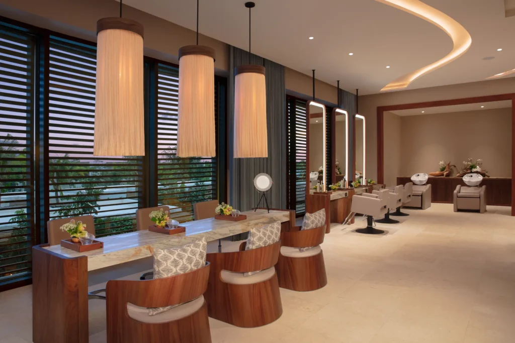 Modern spa salon with styling chairs and mirrors at Secrets Playa Blanca Costa Mujeres, offering luxury beauty services in a tranquil setting.