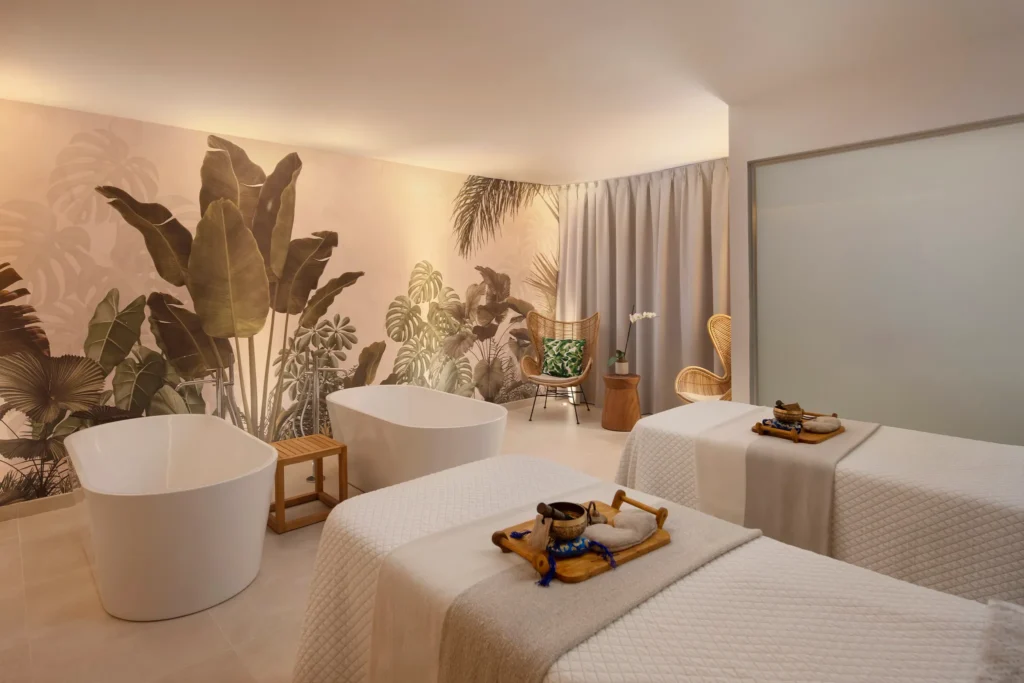 Couples spa treatment room with soaking tubs and massage beds at Secrets Playa Esmeralda Resort & Spa.