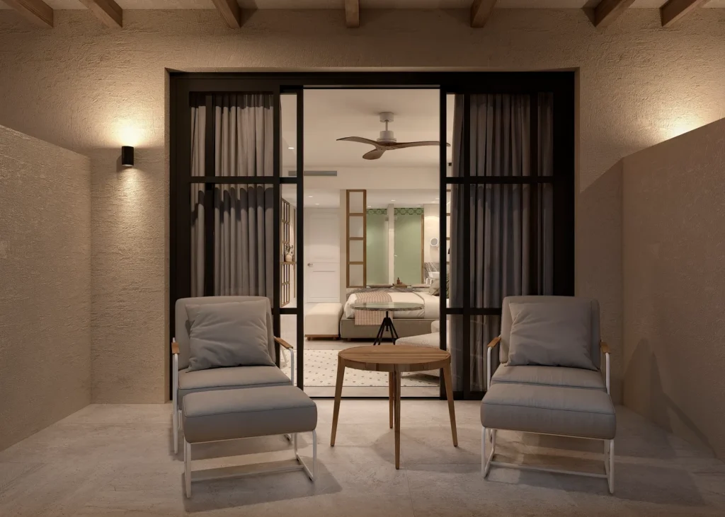 Junior Suite Partial Ocean View private balcony with lounge chairs overlooking the ocean at Secrets Playa Esmeralda.