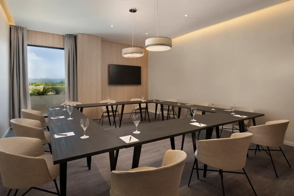 Modern meeting room with U-shaped table setup at Secrets Playa Esmeralda Resort & Spa.