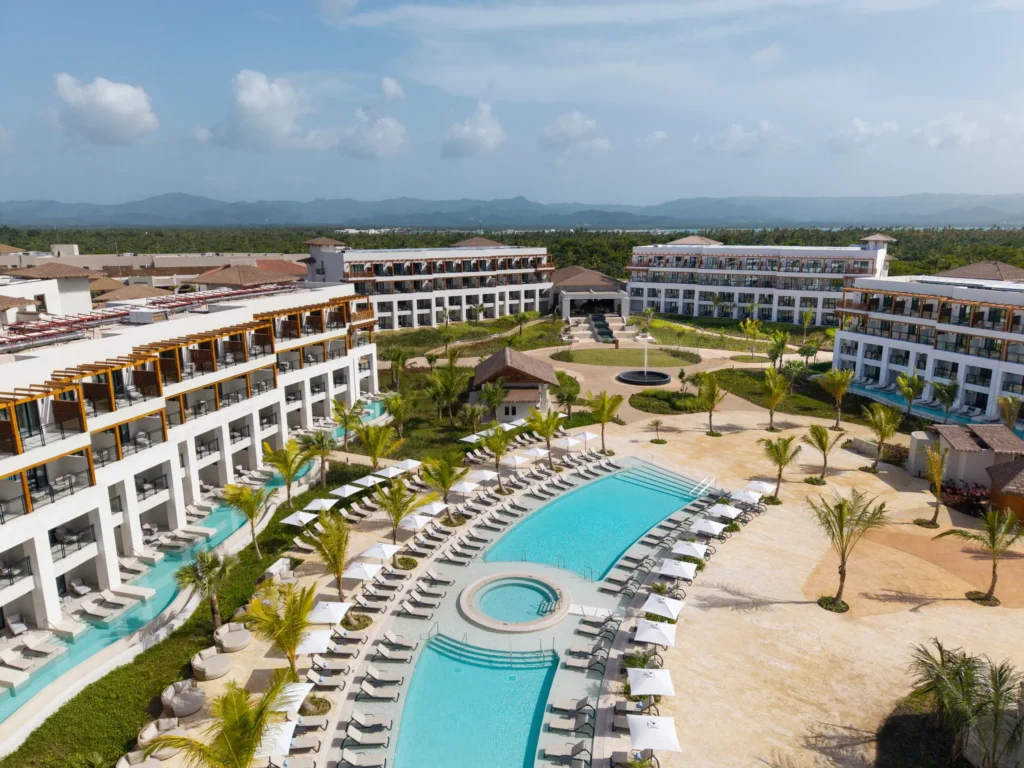 Aerial view of the central courtyard and pool surrounded by suites at Secrets Playa Esmeralda Resort & Spa.