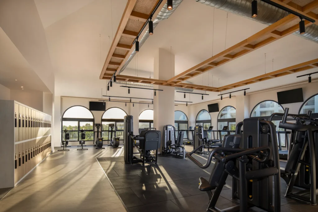 Modern fitness center with cardio and strength equipment at Secrets Playa Esmeralda Resort & Spa.