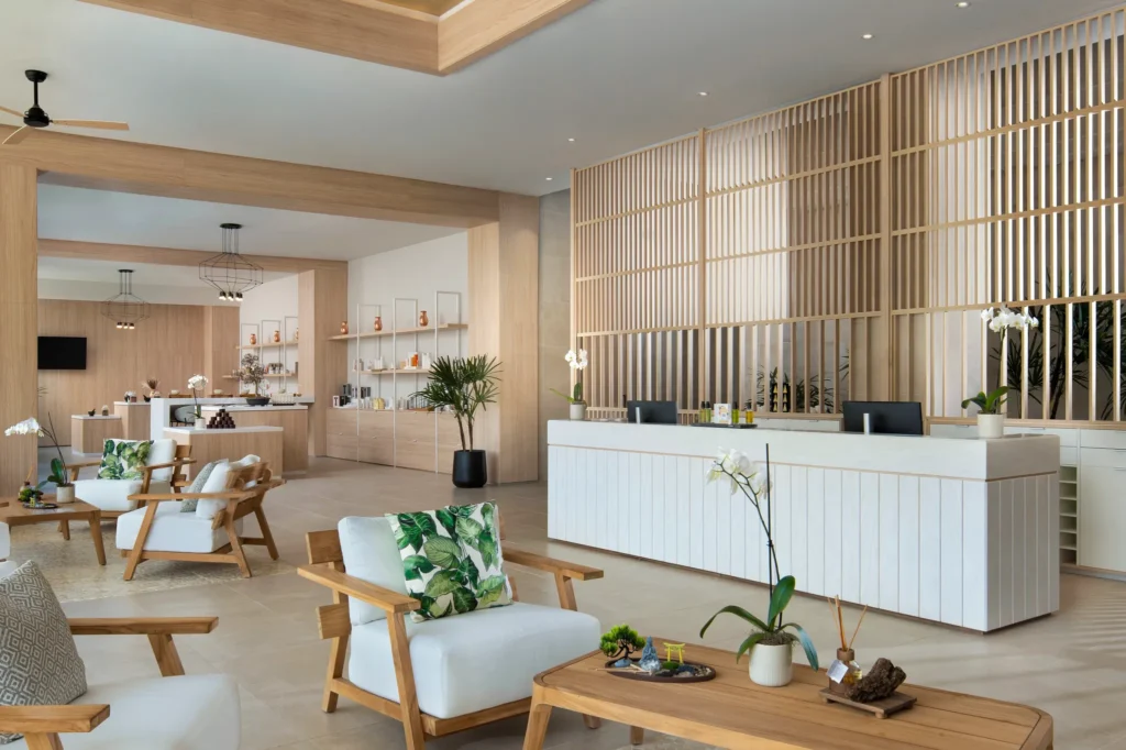 Modern spa reception desk with tropical accents at Secrets Playa Esmeralda Resort & Spa.