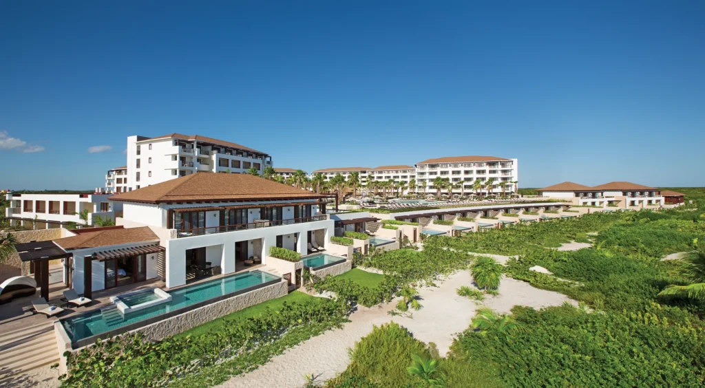Aerial view of the main pool and beachfront at Secrets Playa Mujeres Golf & Spa Resort in Cancun.