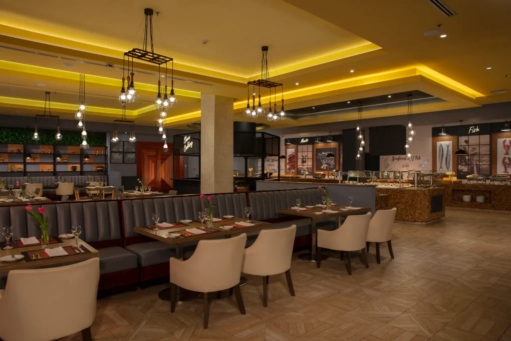 Market Café international buffet at Secrets Playa Mujeres Golf & Spa Resort featuring a modern farmers market-style dining area with gourmet food stations.