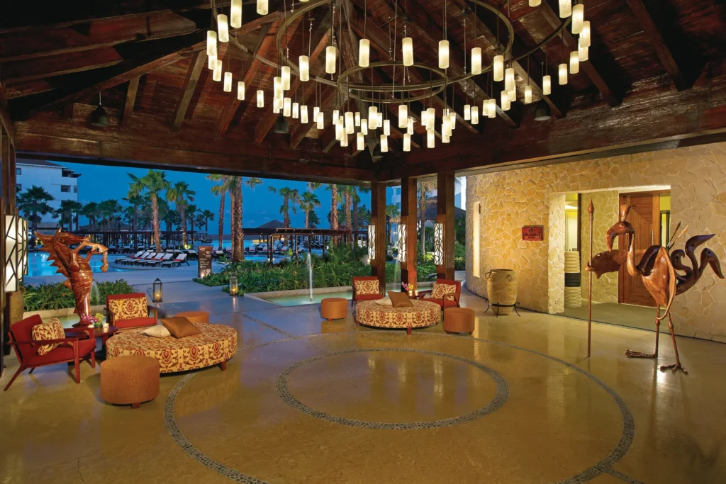 Elegant Preferred Club lounge lobby with seating and chandeliers at Secrets Playa Mujeres Golf & Spa Resort.