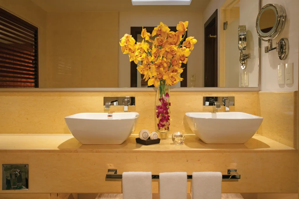 Junior Suite Partial Ocean View bathroom vanity with double sinks at Secrets Playa Mujeres Golf & Spa Resort.