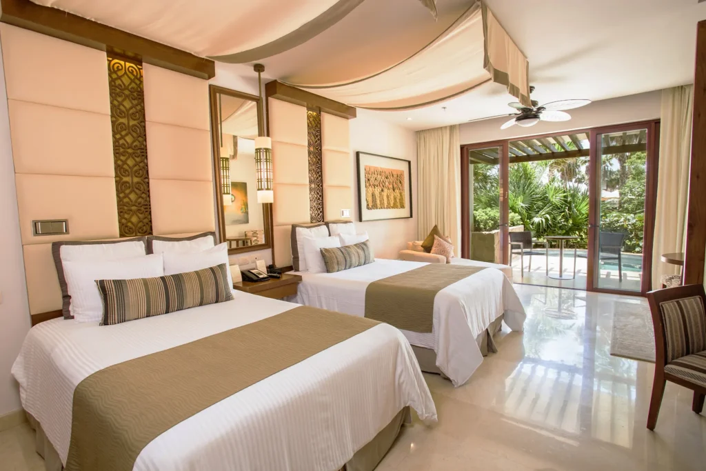 Junior Suite Swim Out double beds with private terrace and pool access at Secrets Playa Mujeres Golf & Spa Resort.