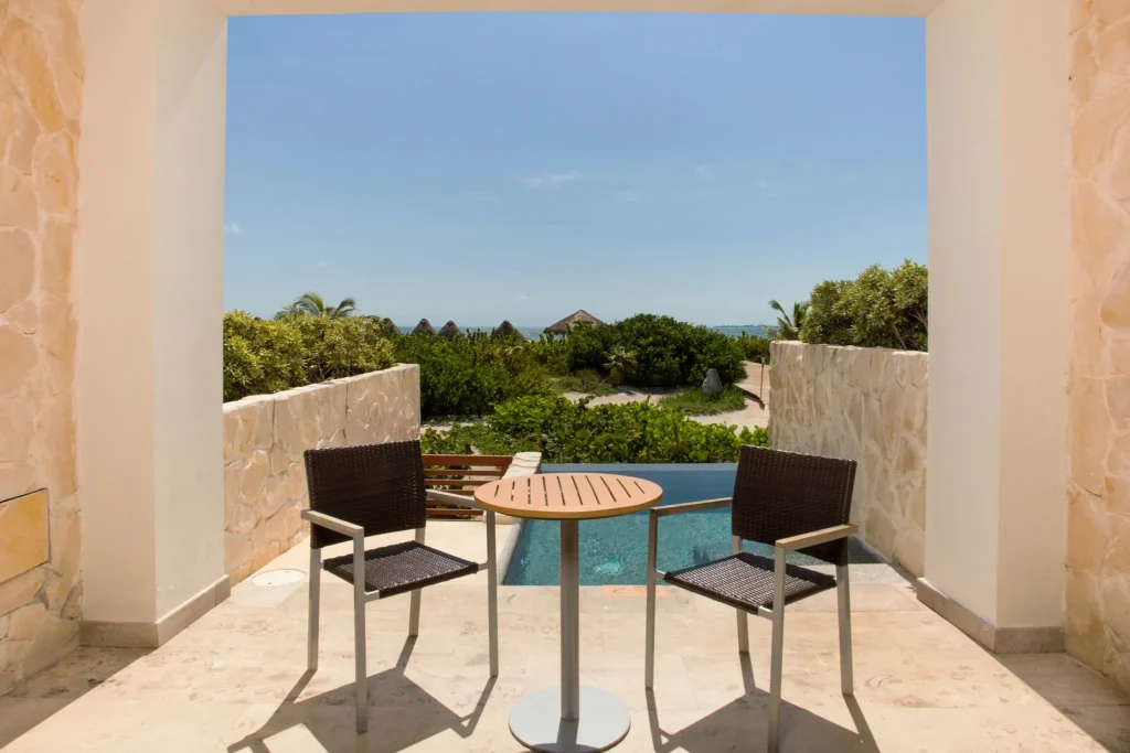 Preferred Club Junior Suite Ocean Front terrace with plunge pool and seating at Secrets Playa Mujeres Golf & Spa Resort.