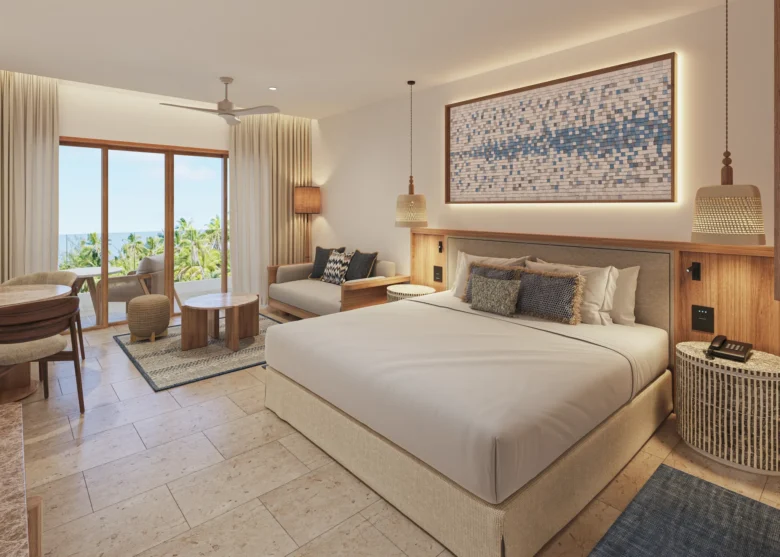 Preferred Club Junior Suite Ocean View Swim Out king bedroom with balcony access at Secrets Playa Mujeres Golf & Spa Resort.