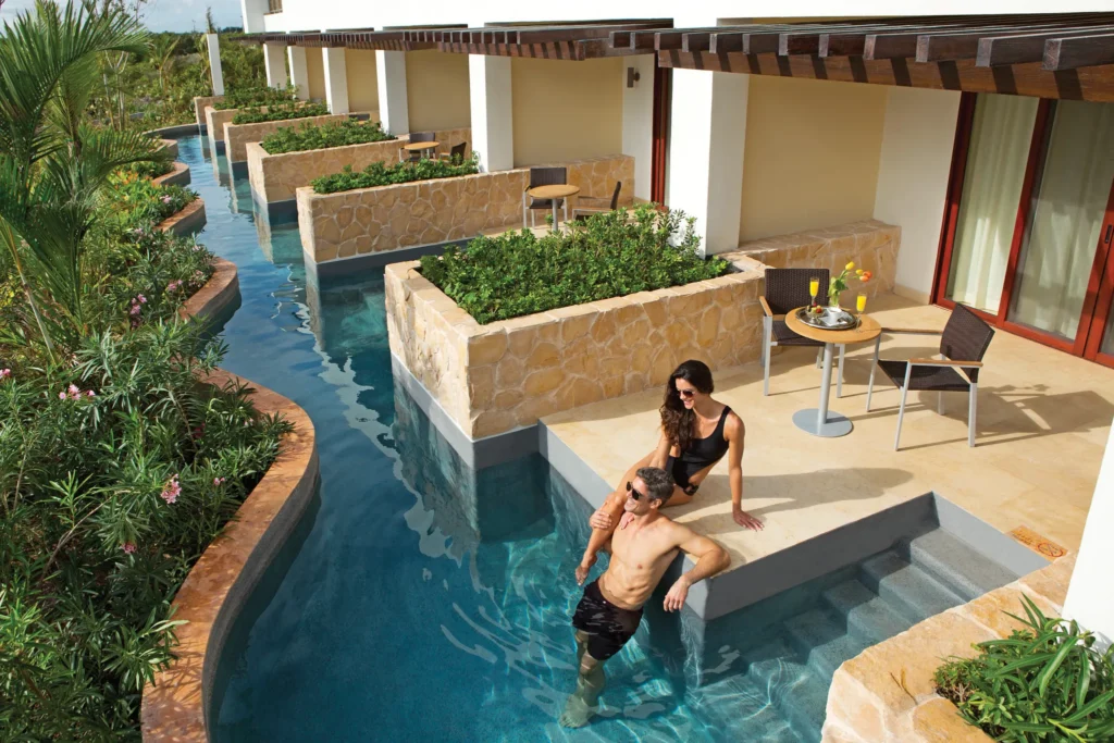 Preferred Club Junior Suite Ocean View Swim Out shared pool terrace with direct water access at Secrets Playa Mujeres Golf & Spa Resort.