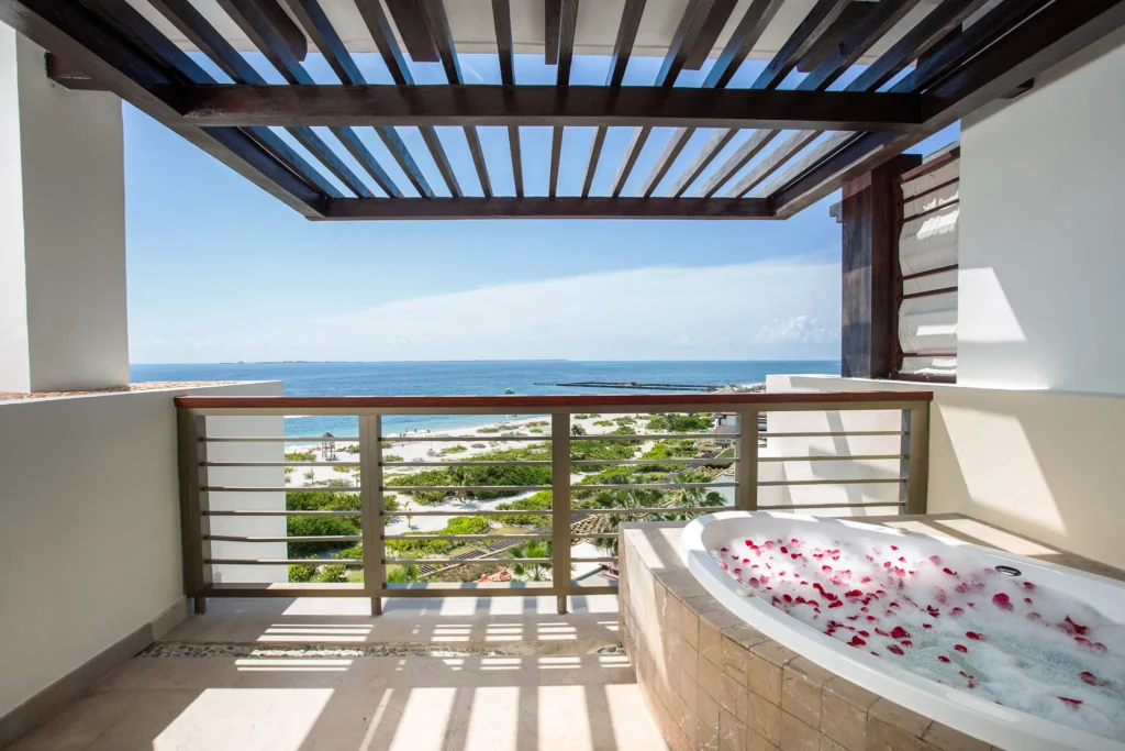 Preferred Club Master Suite Ocean Front balcony with private hot tub and ocean view at Secrets Playa Mujeres Golf & Spa Resort.