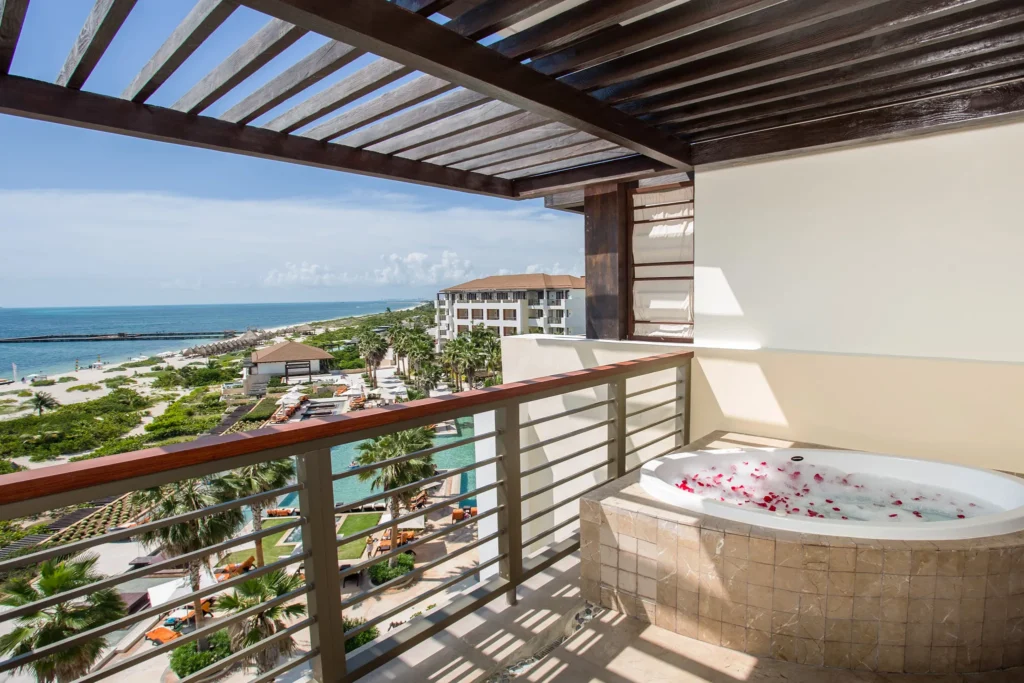 Preferred Club Master Suite Ocean View balcony with private hot tub overlooking the ocean at Secrets Playa Mujeres Golf & Spa Resort.