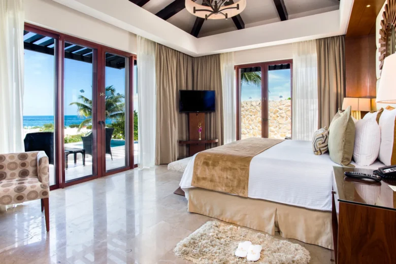 Presidential Suite king bedroom with ocean view and terrace access at Secrets Playa Mujeres Golf & Spa Resort.