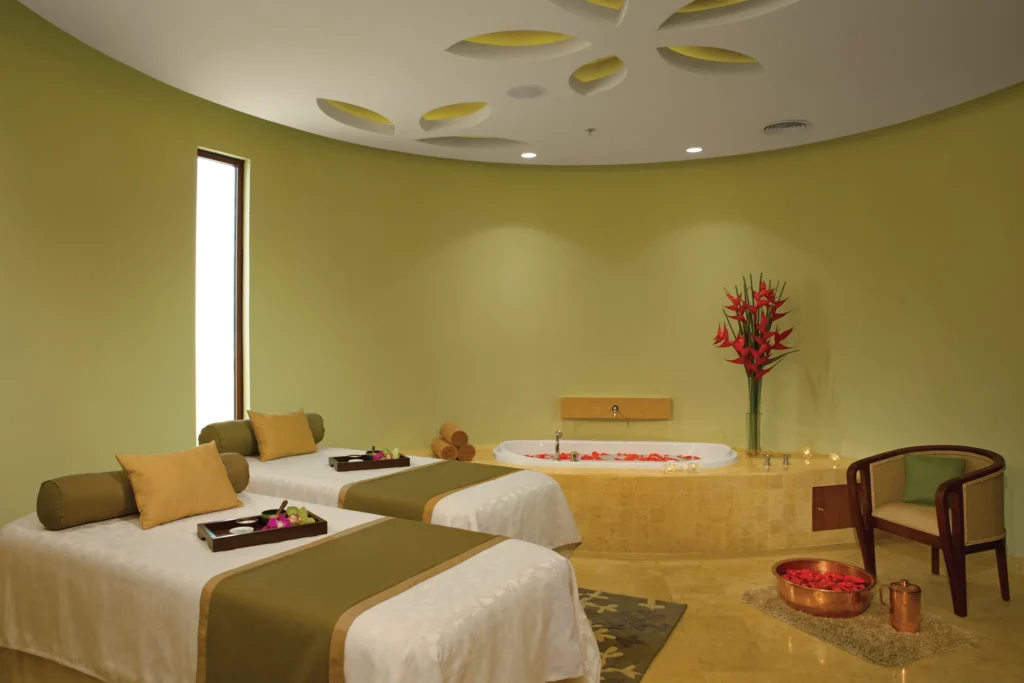 Luxury couples spa treatment room with massage beds and soaking tub at Secrets Playa Mujeres Golf & Spa Resort.